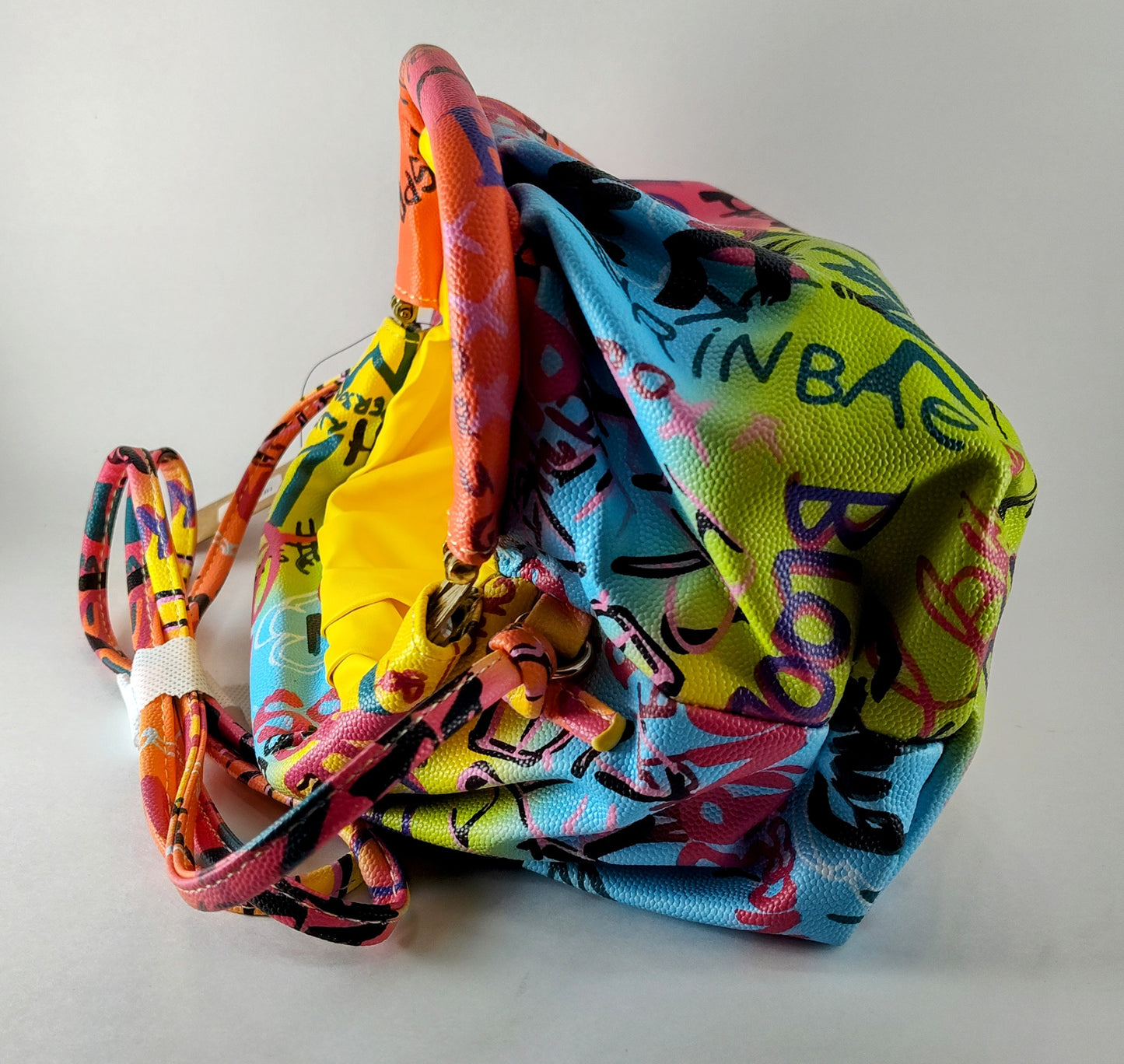 "Multicolor Graffiti Handbag – Edgy, Street Art-Inspired Statement Bag" P 114